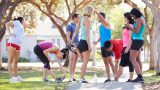 Group Of Runners Warming Up Before Run